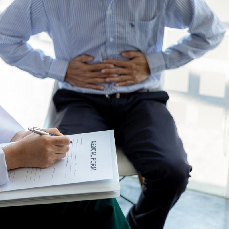 Image of a doctor with a patient who is complaining of pain in the gut, potentially Candida overgrowth or gut dysbiosis