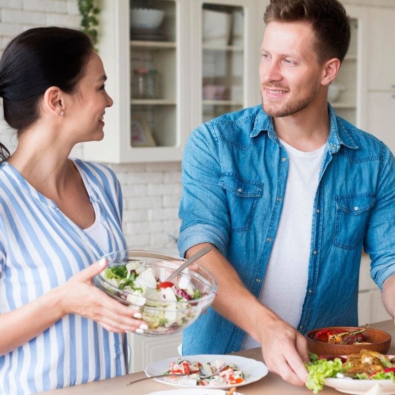A couple preparing an anti-candida diet meal together with a focus on a candida cleanse.